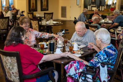 Residents enjoying a meal together in a dining area