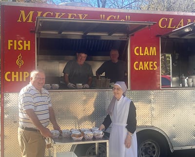 Residents and staff serving food from a mobile food truck