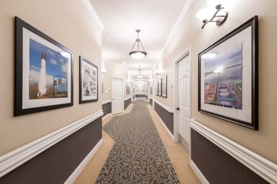 Hallway with framed artwork in an assisted living facility