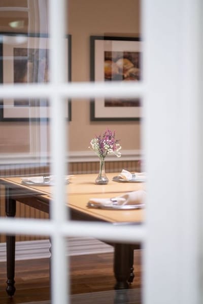 Dining area with a vase of flowers on the table