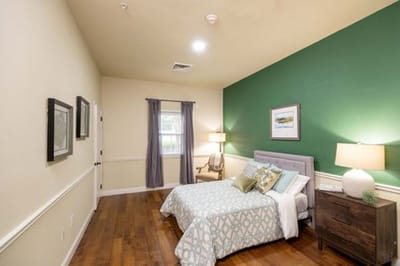 Private room in a senior living facility with a bed and decor