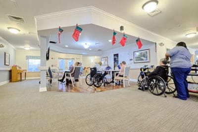 Residents engaged in a group activity in a cheerful common area