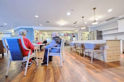 Residents socializing in a common area with modern decor