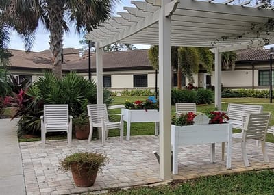 Outdoor seating area with flowers and shade