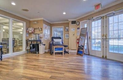 Common area with wooden floors and natural light