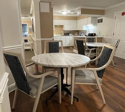 Common area with dining tables and kitchen