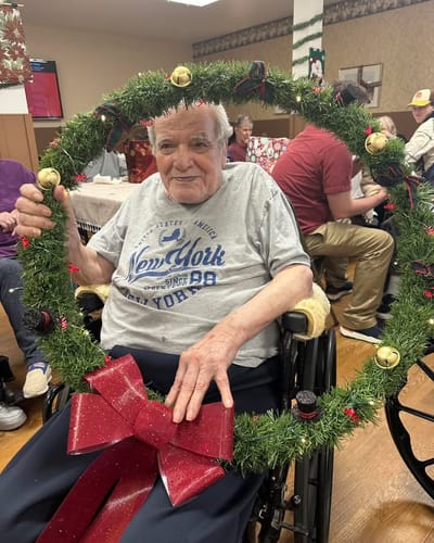 Resident enjoying festive celebration with wreath