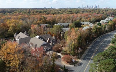 Aerial view of senior living cottages surrounded by fall foliage