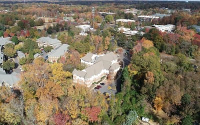 Aerial view of a senior living facility surrounded by autumn foliage