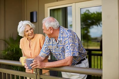 Seniors enjoying beverages on a balcony