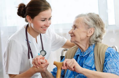 Nurse assisting elderly resident in a warm interaction