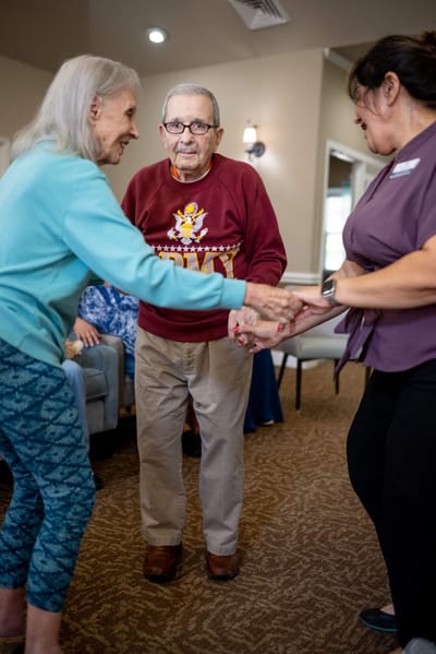 Residents engaging in an activity with staff