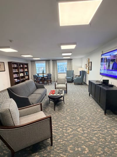 Bright common area with seating and a TV
