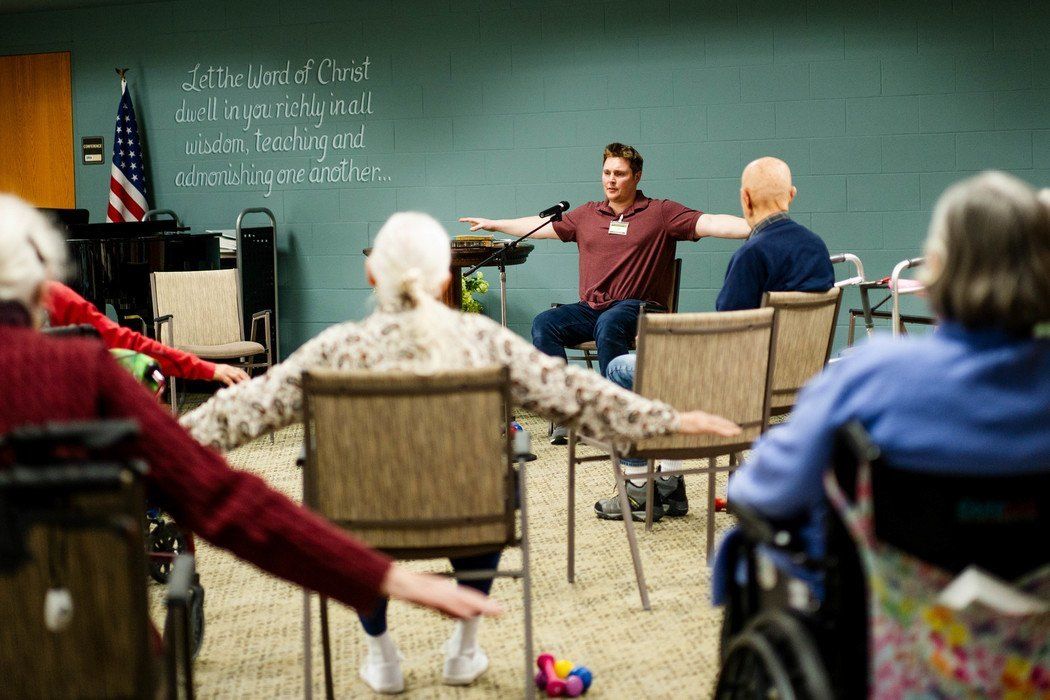Residents participating in a seated exercise class