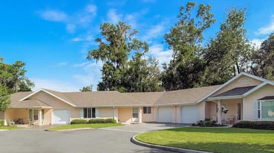 Exterior view of a senior living facility with gardens