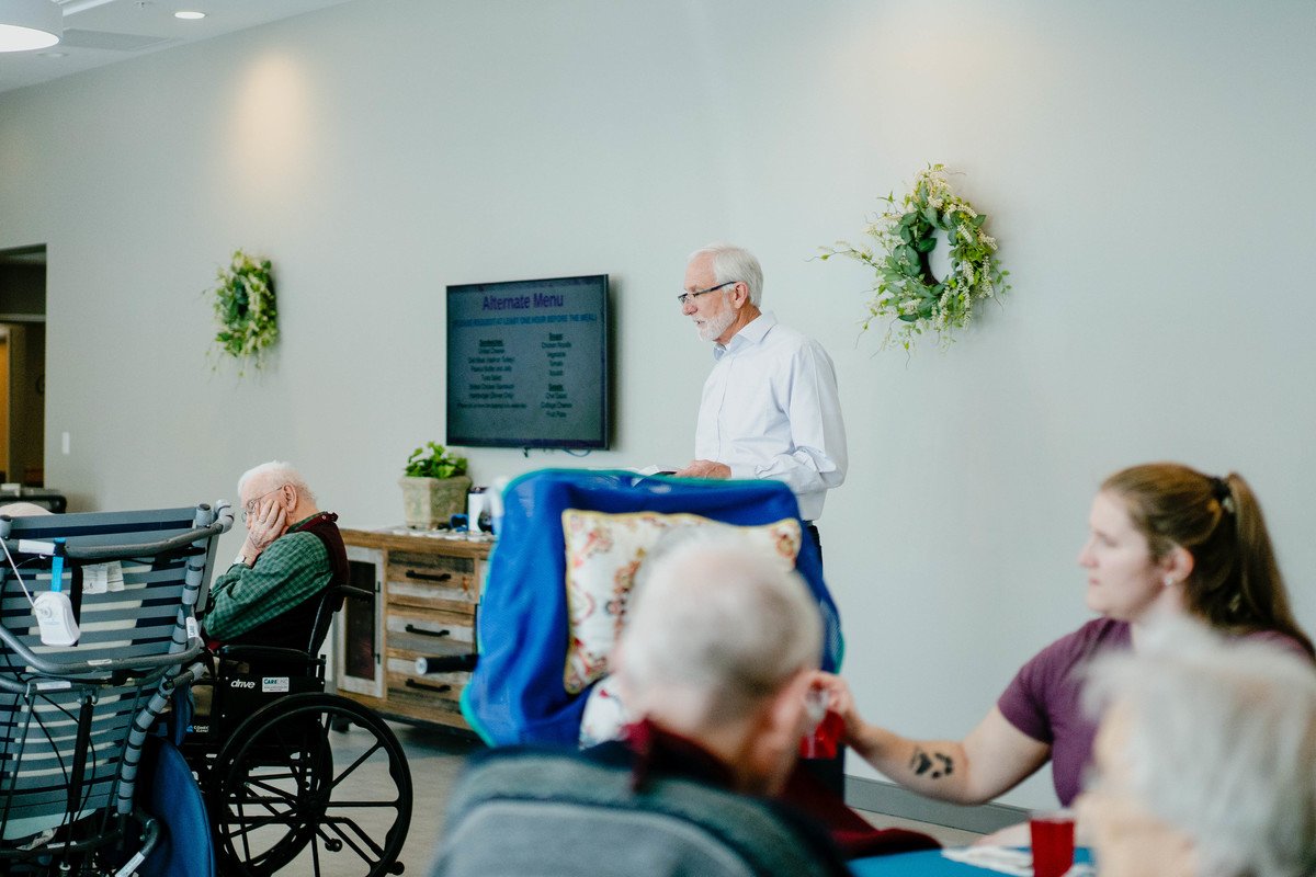 Residents engaging in an activity led by staff member