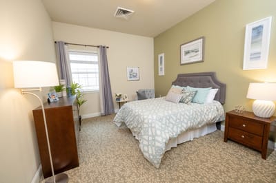 Cozy private resident room with bed and decor