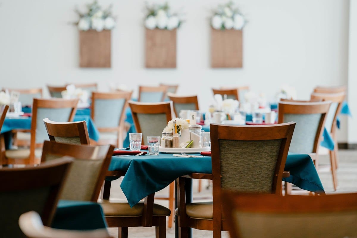 Dining room set with blue tablecloths and floral decor