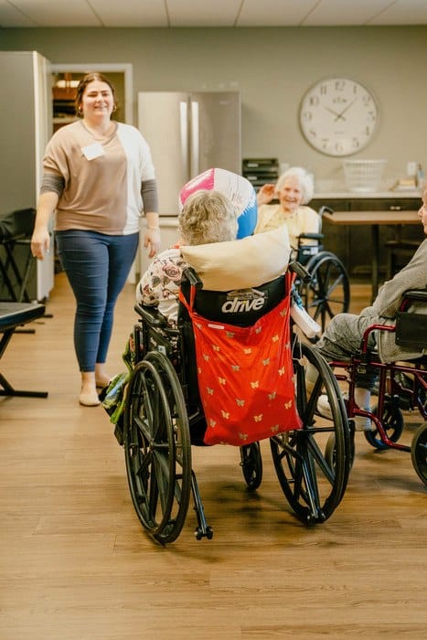 Residents participating in an activity with staff member