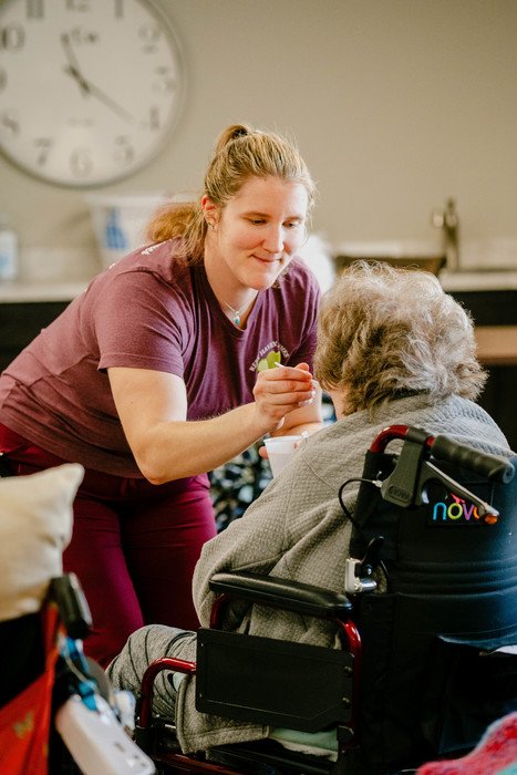 Staff assisting resident during a group activity