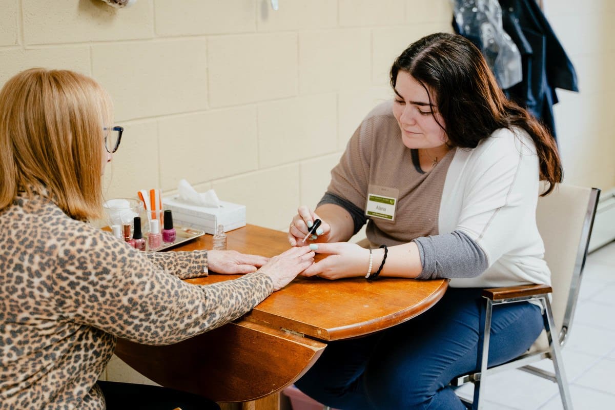 Resident enjoying a manicure with staff assistance