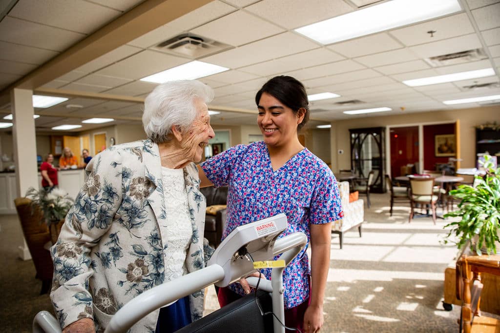 Staff member assisting a resident in the common area
