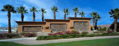 Entrance view with palm trees and landscaping