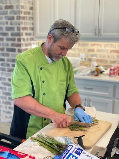 Chef preparing fresh asparagus in a kitchen