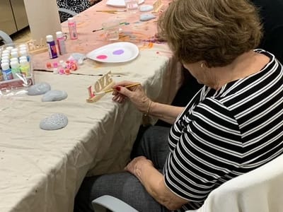 Resident participating in an art activity at a table
