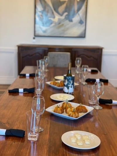 Dining room table set with food and drinks for a gathering
