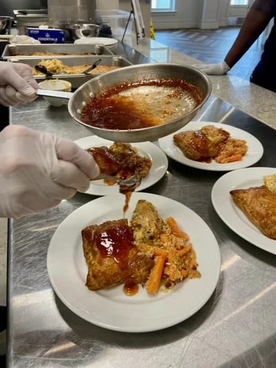 Food being plated in the dining area for residents