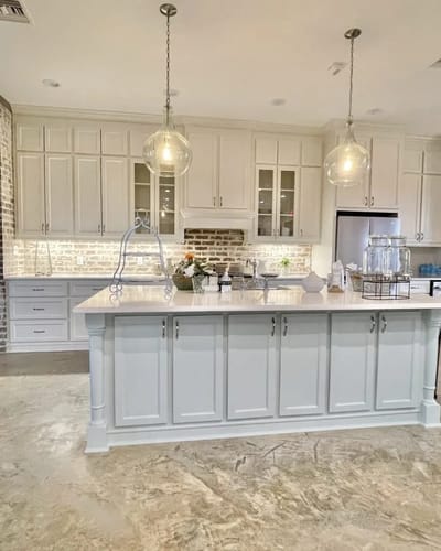 Modern kitchen interior with large island and pendant lights