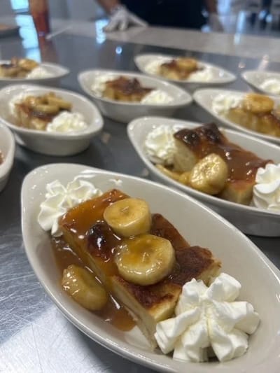 Delicious dessert served with bananas and whipped cream