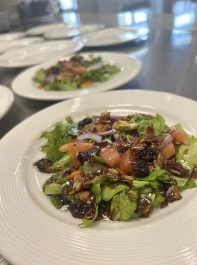 A close-up of a fresh salad plated for residents
