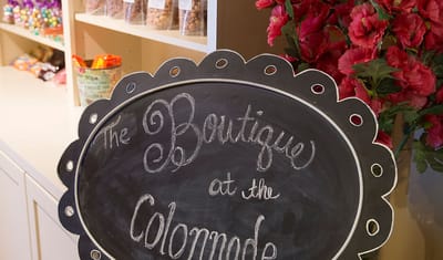 Chalkboard sign for The Boutique at the Colonnade