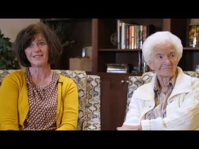 Two residents conversing in a common area