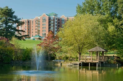 Outdoor view of a building with a pond and gazebo