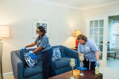Staff cleaning a resident's living area