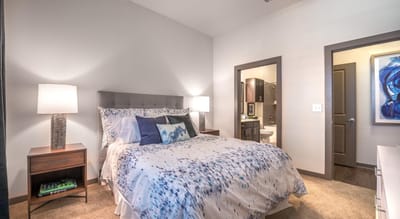 Well-decorated private resident room with a bed and lamp