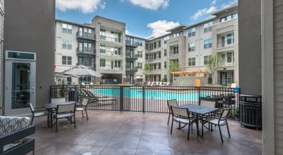 Outdoor pool area with lounge chairs and accessible seating
