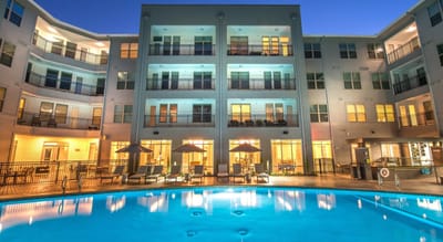 Exterior view of the facility with pool and gathering area