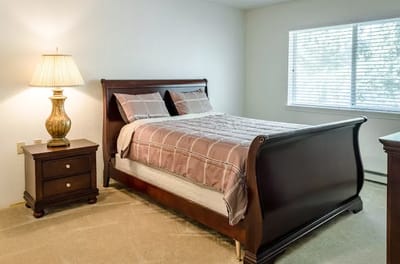 Cozy bedroom setup with bedside lamp and window