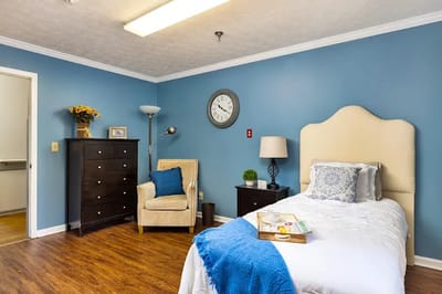 Private resident room with a bed and chair