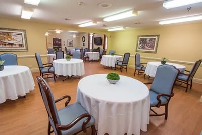 Common area in a senior living facility with tables and chairs