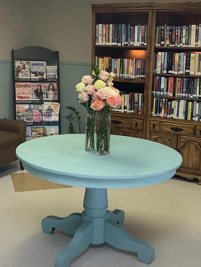 Interior view of a cozy reading area with a flower vase