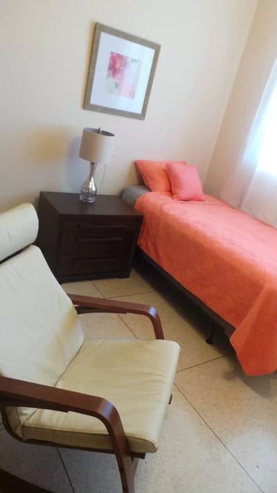 Private resident room with a bed and chair