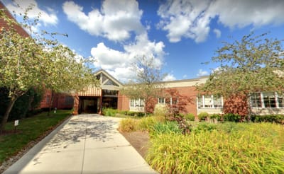 Exterior view of Tanglewood Manor with landscaped path