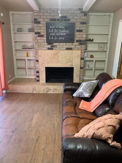 Cozy common area with a leather couch and fireplace