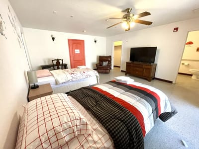 Brightly furnished resident room with a bed and seating area
