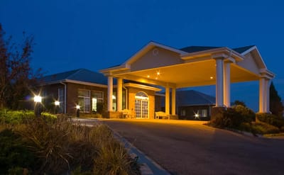 Exterior view of the facility at night with lighting